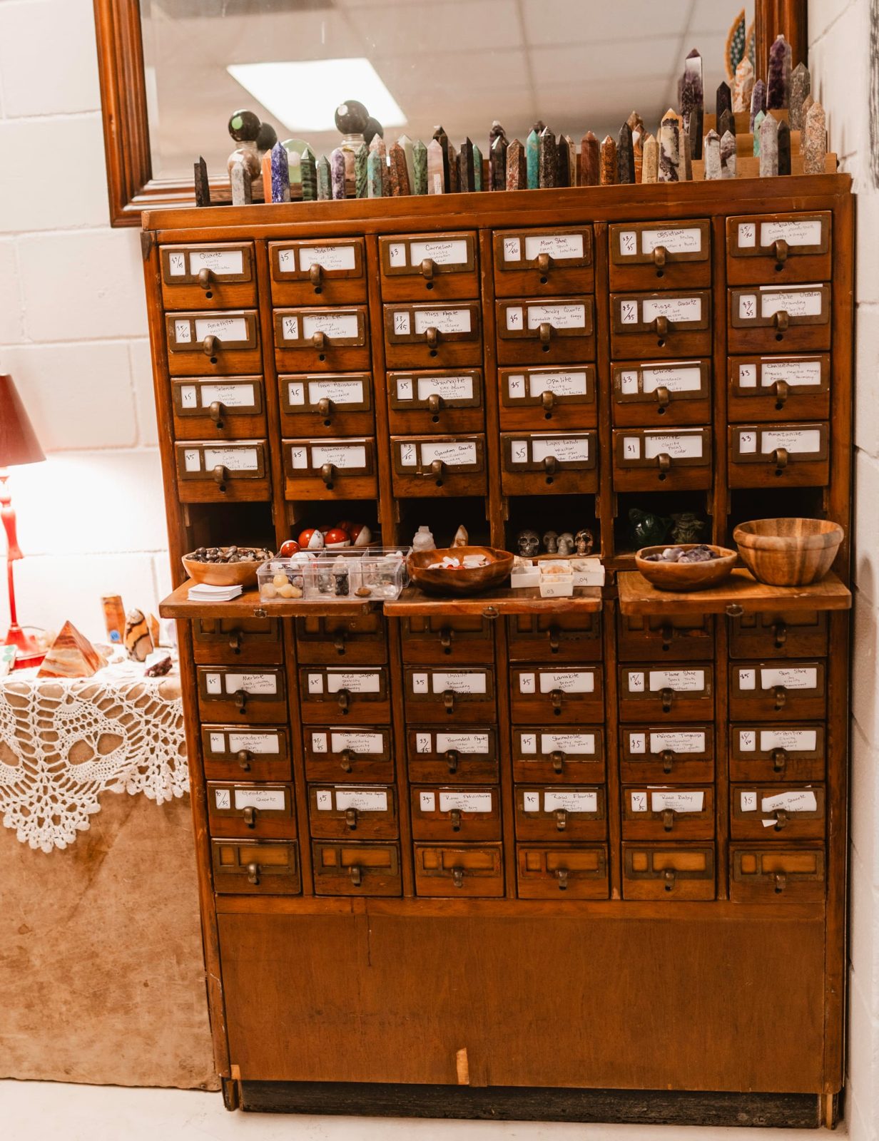 Restored 1930s apothecary drawers from the old Lovelace Pharmacy, holding herbs and remedies